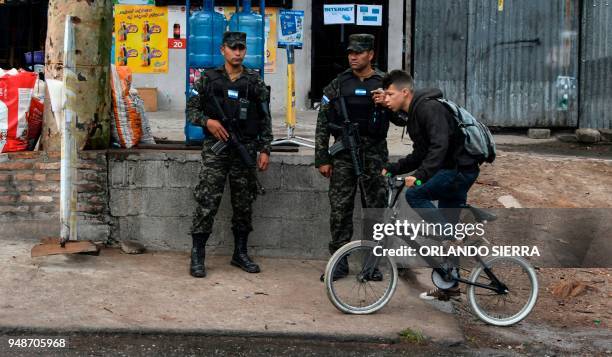 Military police officers stand guard in the surroundings of a school in Tegucigalpa, on April 18, 2018. - Students are also victims of the prevailing...