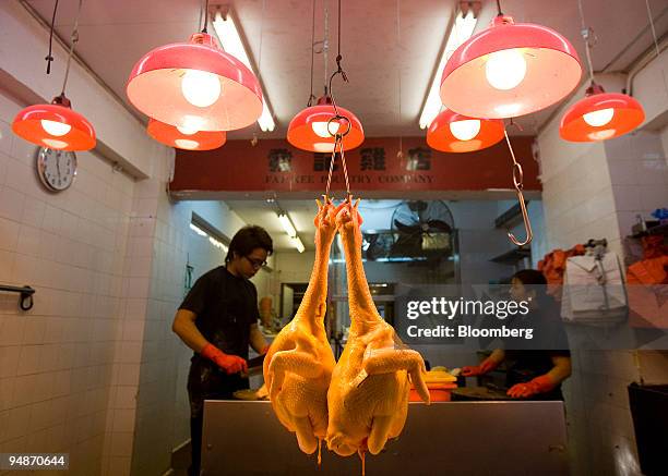Cooked chickens hang for sale at a market in Hong Kong, China, on Wednesday, Mar 12, 2008. Hong Kong's government is on "full alert'' after several...