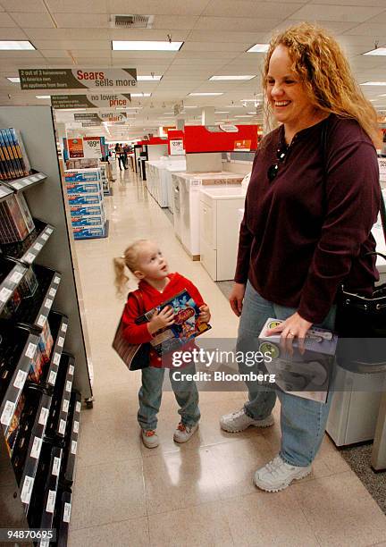 Stephanie Wolf laughs while her daughter Madison picks out DVD's at Sears in El Cajon, California on Thursday, October 21, 2004. Sears, Roebuck &...