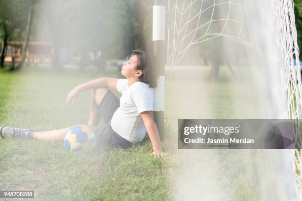 kids playing soccer on field - kicking tire stock pictures, royalty-free photos & images