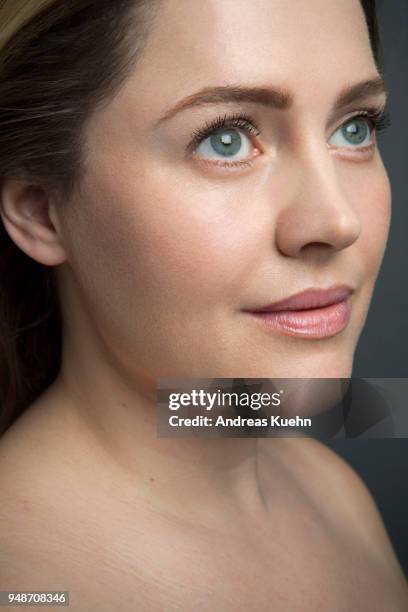 woman in her late thirties in a three-quarter position looking off camera with bare skin, bare shoulders and a soft smile, close up portrait. - andreas kuehn bildbanksfoton och bilder