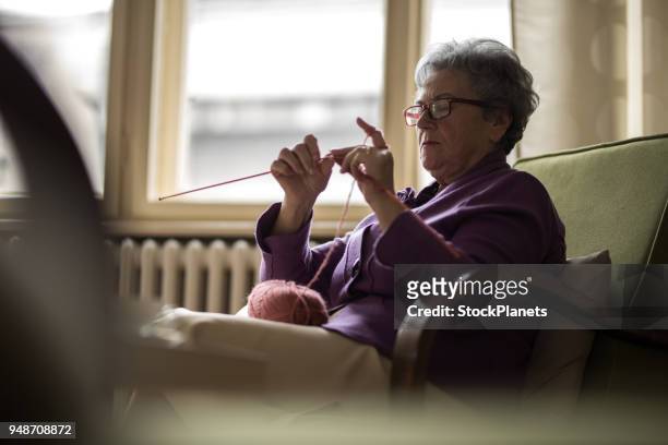 senior women knitting at home - knitting stock pictures, royalty-free photos & images