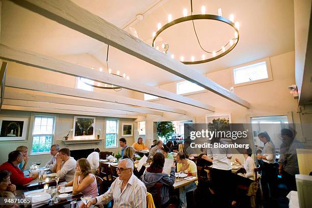 Patrons dine at Tutto il Giorno, a restaurant located at 6 Bay Street in Sag Harbor, New York, U.S., on Sunday, July 27, 2008. When the restaurant's...