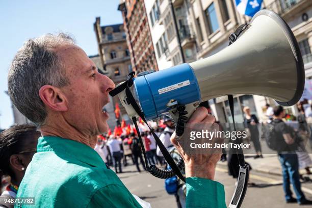 Human rights campaigner Peter Tatchell shouts into a megaphone during an LGBT rights protest outside Commonwealth House during the 'Commonwealth...