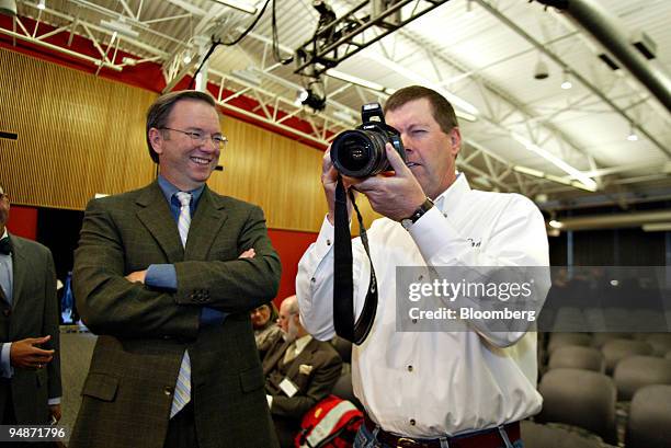 Scott McNealy, CEO of Sun Microsystems, right, takes a picture of the press photographers prior to the start of a press conference with Dr. Eric...