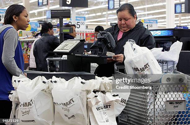 Barbara Hernandez, right, checks her receipt after shopping at the grand opening of a Wal-Mart store in Evergreen Park, Illinois, Friday, January 27,...