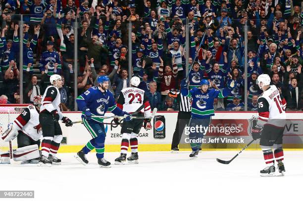 Alexander Edler and Henrik Sedin of the Vancouver Canucks celebrate the overtime winning goal of Daniel Sedin of the Vancouver Canucks on Darcy...