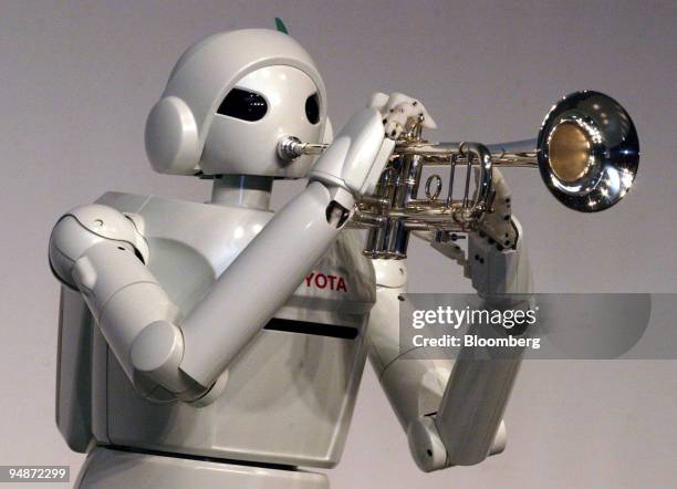 Toyota Partner Robot" plays a trumpet during a press confernce by Toyota Motor Corp. In Tokyo, Japan Thursday, March 11, 2004.