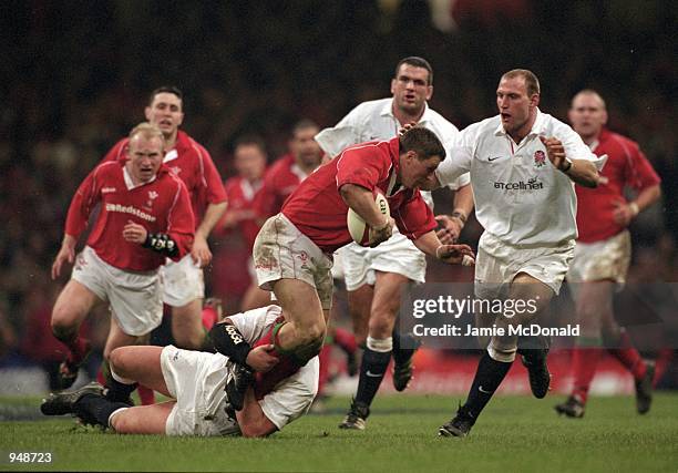 Scott Gibbs of Wales is tackled by Phil Vickery and Lawrence Dallaglio of England during the Lloyds TSB Six Nations Championship 2001 match played at...