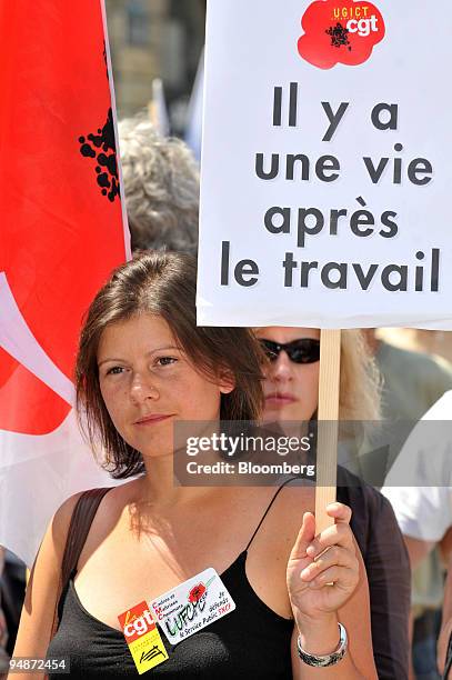 Member of the Confederation francaise de l'encadrement-Confederation generale des cadres union holds up a sign reading "There's life after work!" in...