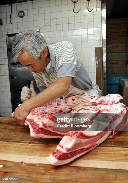 Butcher carves up a side of domestic beef at a shop in Tokyo Wednesday, October 5, 2005. The prospects of Japan ending a two-year ban on U.S. Beef...