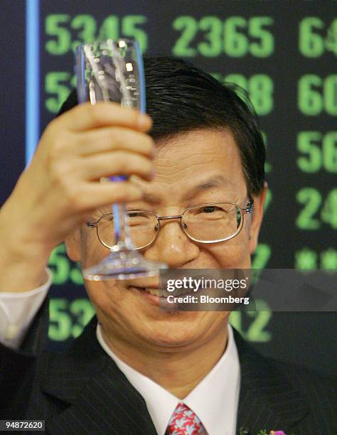 China Shenhua Energy Co. Chairman Chen Biting toasts the success of his company Wednesday, June 15, 2005 after it began trading on the Hong Kong...