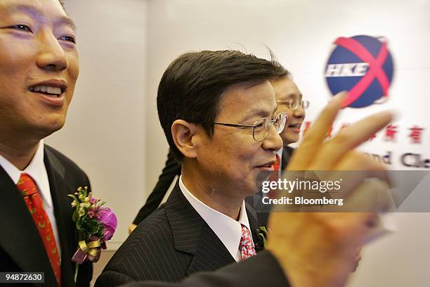 China Shenhua Energy Co. Chairman Chen Biting, right, and CFO Ling Wen, left, leave the Hong Kong Stock Exchange Wednesday, June 15, 2005 after...