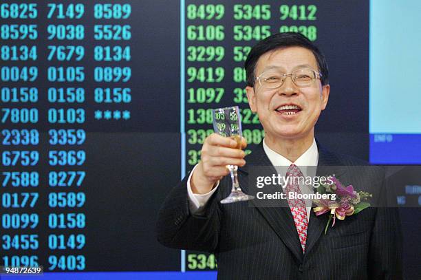 China Shenhua Energy Co. Chairman Chen Biting toasts the success of his company Wednesday, June 15, 2005 after it began trading on the Hong Kong...