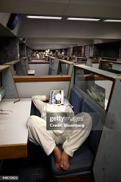 Trader sleeps in the trading hall of the Karachi Stock Exchange, in Karachi, Pakistan, on Monday, Oct. 13, 2008. Pakistani police ringed the nation's...