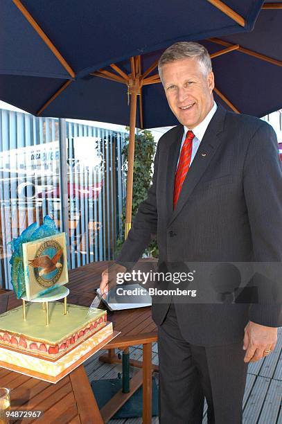 Louis Chenevert, president of Pratt & Whitney, poses with a cake celebrating the 20th birthday of the company during the Paris Air Show in Le...