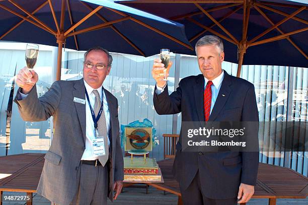 Louis Chenevert, president of Pratt & Whitney, right, and Steve Heath, president of commercial engines, celebrate the 20th birthday of the company...