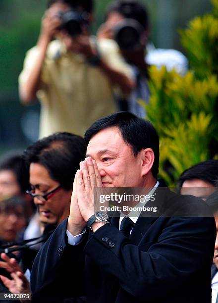 Thaksin Shinawatra, former prime minister of Thailand and owner of the Manchester City football club, acknowledges a crowd as he arrives at the...