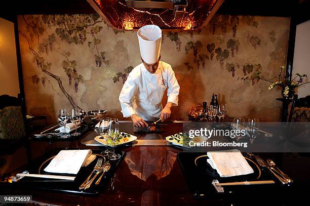 Yudai Hanno, head chef at Omotesando Ukai-tei teppan-yaki restaurant, prepares steak on a griddle at the restaurant in the Omotesando district of...