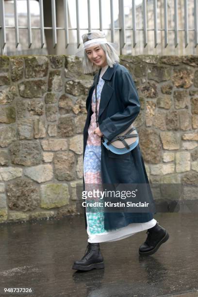 Fashion blogger and model Irene Kim wears a Celine jacket, Chanel hat, Loewe bag and dress day 5 of Paris Womens Fashion Week Spring/Summer 2018, on...