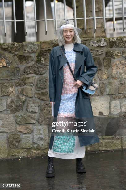 Fashion blogger and model Irene Kim wears a Celine jacket, Chanel hat, Loewe bag and dress day 5 of Paris Womens Fashion Week Spring/Summer 2018, on...