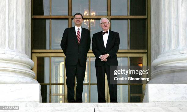 Supreme Court Chief Justice John Roberts, left, and Supreme Court Justice John Paul Stevens pose for photographers on the steps of the U.S. Supreme...