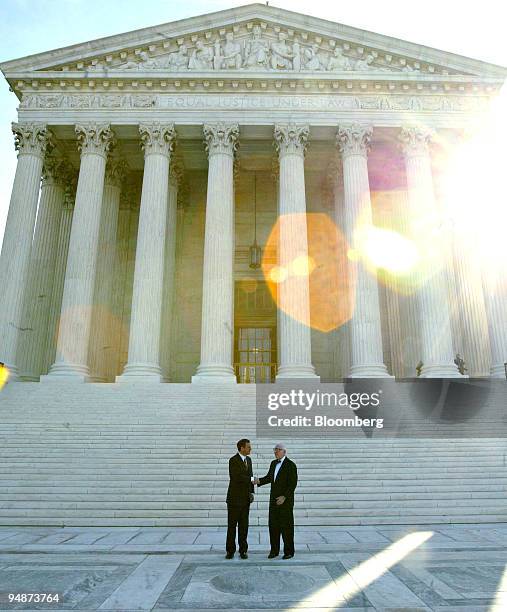 Supreme Court Chief Justice John Roberts, left, and Supreme Court Justice John Paul Stevens pose for photographers outside of the U.S. Supreme Court...