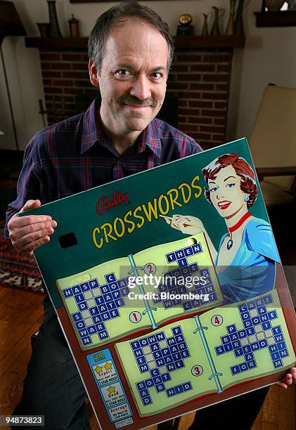 Will Shortz, puzzle editor for The New York Times and founder of the American Crossword Puzzle Tournament, poses with a glass panel from a 1950's...