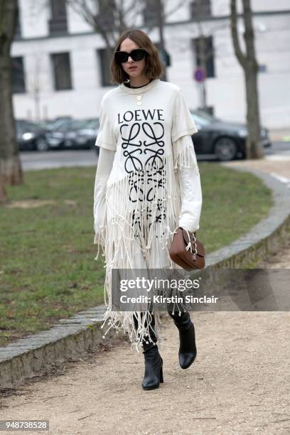 Fashion influencer Candela Novembre wears a Loewe dress, Louis Vuitton bag, Celine sunglasses and Stuart Weitzman boots day 5 of Paris Womens Fashion...