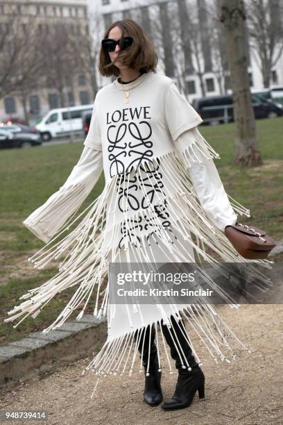 Fashion influencer Candela Novembre wears a Loewe dress, Louis Vuitton bag, Celine sunglasses and Stuart Weitzman boots day 5 of Paris Womens Fashion...