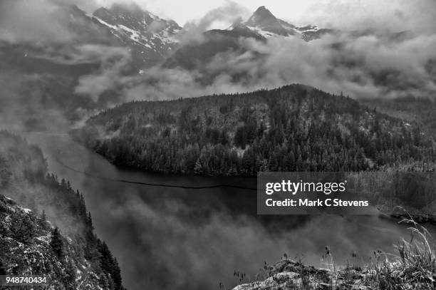 overcast skies over mountains and diablo lake - diablo lake stock pictures, royalty-free photos & images