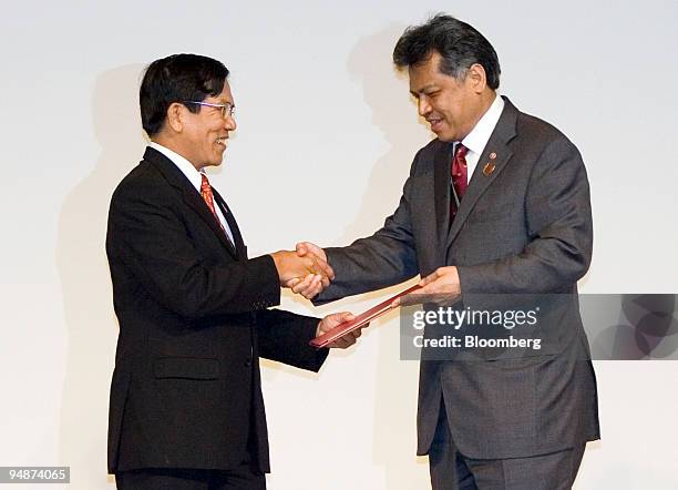 Nyan Win, Myanmar's minister of foreign affairs, left, shakes hands with Surin Pitsuwan, Association of Southeast Asian Nations secretary-general,...