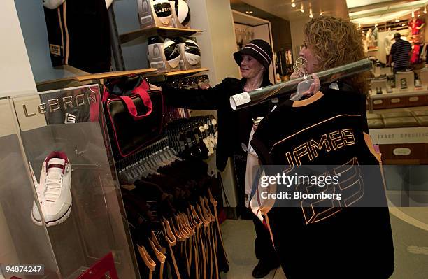 Pamela Brown, right, shops for LeBron James merchandise for her son with friend Beverly Mijalkovich in a Niketown store in New York on March 9, 2004....