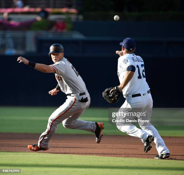 Joe Panik of the San Francisco Giants is tagged out in a run down by Chase Headley of the San Diego Padres during the first inning of a baseball game...