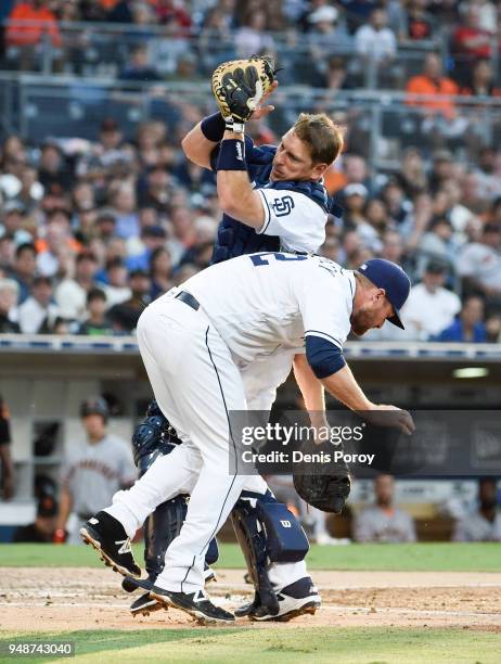 Ellis of the San Diego Padres collides with Chase Headley as he makes the catch on a foul ball hit by Gorkys Hernandez of the San Francisco Giants...