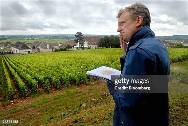 Bjorn von Below, vice president of EFG Bank, uses a local map to locate the Chassagne Clos Saint Jean vines in the Burgundy village of...