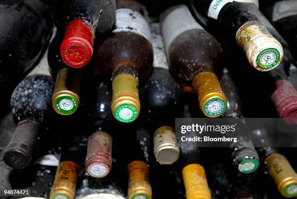 Old and dusty wine bottles sit in the cellar at the Clos Saint Jean vineyard, in the Burgundy village of Chassagne-Montrachet, France, on Tuesday,...