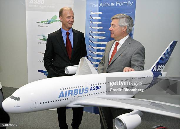 Tom Enders, chief executive officer of Airbus SAS, left, speaks with John Leahy, chief operating officer of Airbus SAS, in front of a model of the...