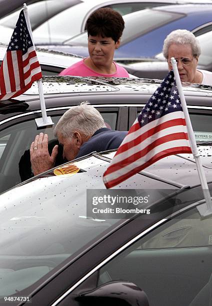 Brenda Leibfritz, center, watches as her father Robert Thomas and mother Lina Thomas shop for car at Oak Brook Toyota in Westmont, Illinois,...