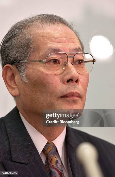 Kunio Takagi, the president of Daiei Inc., listens to a reporter's question during a press briefing at the Tokyo Stock Exchange on October 15, 2004....