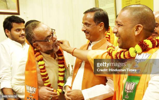 Chief Minister Yogi Adityanath offers sweets to newly elected BJP MLCs, at UP Assembly on April 19, 2018 in Lucknow, India. All 13 candidates,...