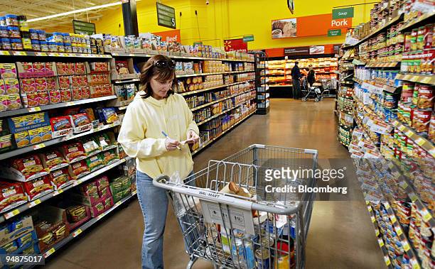 Dana Crawford looks over a grocery list as she shops inside a Wal-Mart store in Highland Village, Texas, U.S., on Monday, Feb. 18, 2008. Wal-Mart...