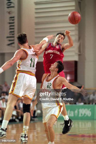 Summer Olympics: Croatia Toni Kukoc in action, pass vs Lithuania Arturas Karnisovas and Arvydas Sabonis during Men's Preliminary Round - Group A game...