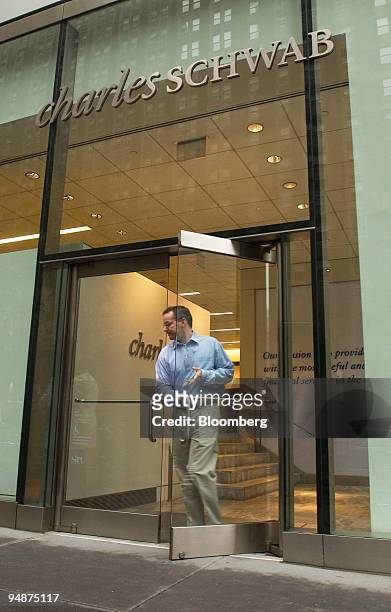 Man exits a Charles Schwab Corp. Brokerage in New York on October 15, 2004. Charles Schwab Corp., the biggest discount brokerage, had a third-quarter...