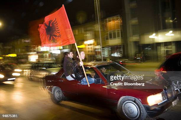 Kosovo Albanian waves the Albanian flag from a vehicle in Pristina, Kosovo, on Saturday, Feb. 16, 2008. Kosovo made final preparations to break free...