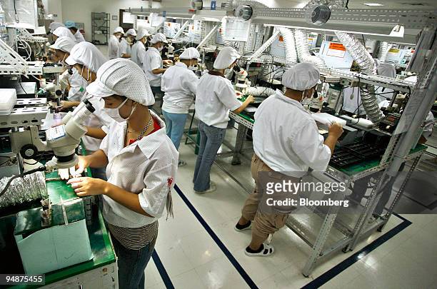 Employees work at the EMS Components Assembly Inc. Electronic manufacturing plant in Laguna Technopark in Santa Rosa, Laguna, the Philippines, on...