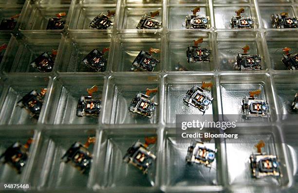 Parts of an optical disk drive are organized in trays at the EMS Components Assembly Inc. Electronic manufacturing plant in Laguna Technopark in...