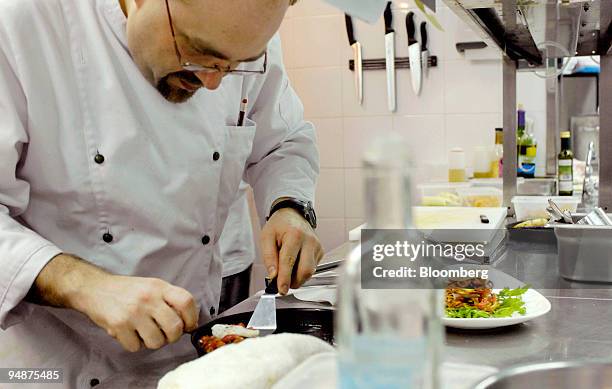 Chef Michael Rickman prepares the "Broiled Black Cod Napoleon" starter in the kitchen of Beo in Hong Kong, China, on Tuesday, July 8, 2008. In a city...