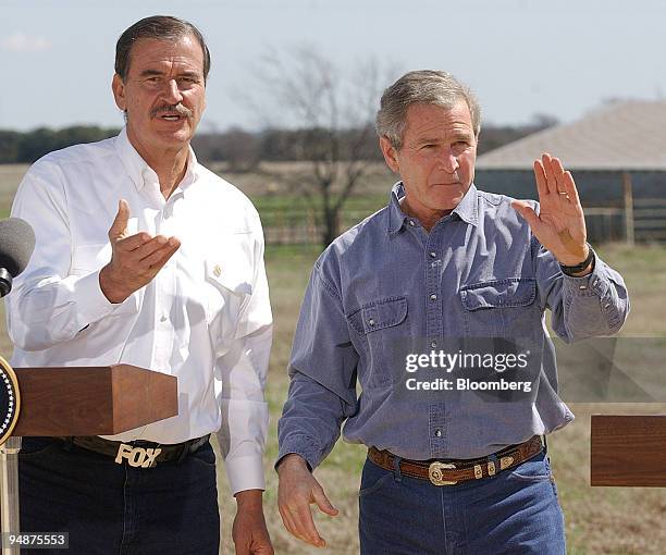 President George W. Bush, right, and Mexico's President Vicente Fox wave to the camera following a joint news conference on Bush's ranch Saturday,...