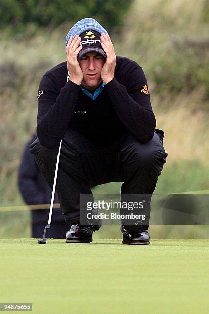 Ian Poulter of England reacts after not being able to read the line of a putt on the 15th green during day one of the British Open Championship at...